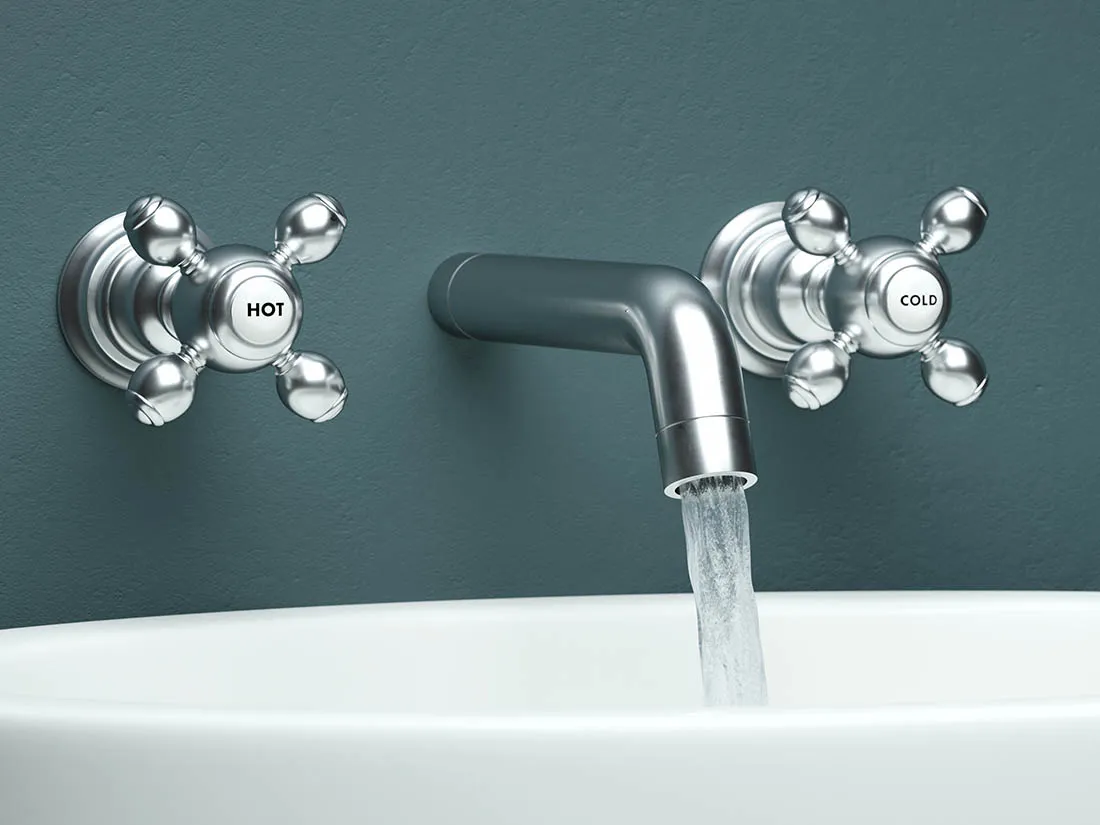 Modern faucet above a bathtub with water coming out